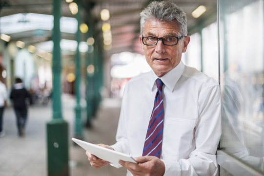 Senior businessman with digital tablet