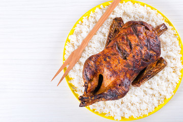 Roasted Whole Duck on a yelow dish, top view
