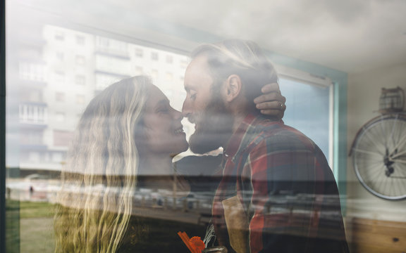 Happy couple kissing in cafe