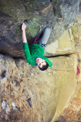 A rock climber climbs up the mountain.