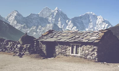 Gordijnen Cute stone cabin with view of mountain peaks © XtravaganT