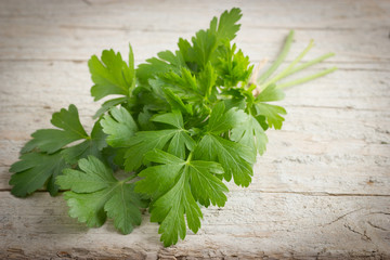 Bunch of fresh parsley on wooden rustic background