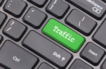 Computer keyboard closeup with "Traffic" text on green enter key