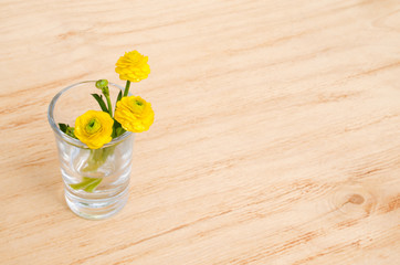 Spring flowers. Spring or summer flowers in glass on a wooden table background. Selective focus.