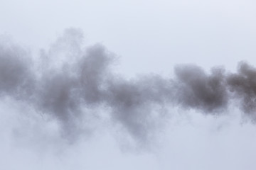 Smoke from a pipe on a cloudy sky