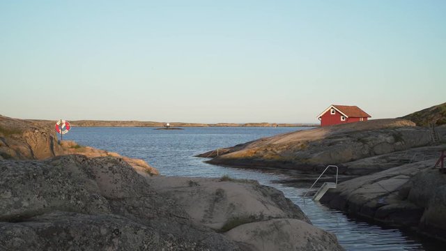 Red cottage and lifebuoy on the Swedish west coast (district Bohuslan).