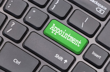 Computer keyboard closeup with "Appointment" text on green enter key