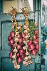 Red onion and garlic draped on old door
