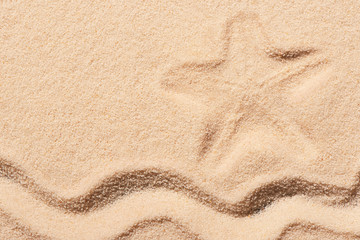 Mark of starfish and wave on sand
