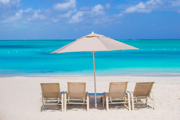 Beach chairs on exotic tropical white sandy beach