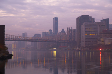 The foggy Manhattan in early morning. View of Queensboro Bridge and Manhattan from Roosevelt Island.