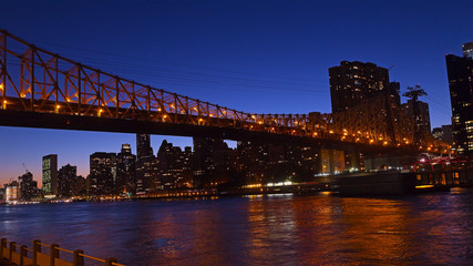 Queensboro Bridge connecting Manhattan to Roosevelt Island. The night view of Manhattan from Roosevelt Island