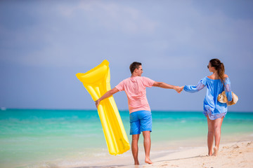 Young family on white beach at tropical vacation