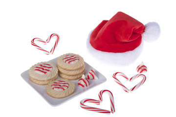 Candy Cane stripped cookies on plate with candy cane hearts isolated on white background