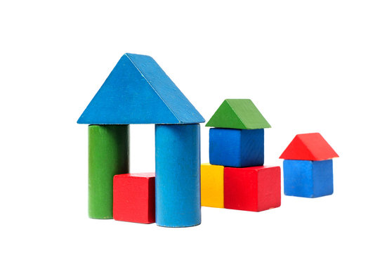 House made of old cubes. Wooden colorful building blocks isolated on white background. Vintage childrens toys.