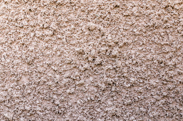  bumpy texture of a rough shapeless shining surface of a wall of
