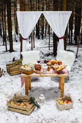 place in winter pine wood decorated for a romantic picnic
