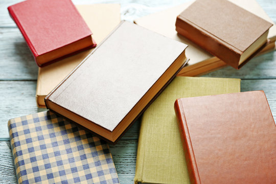 Pile of books on wooden background