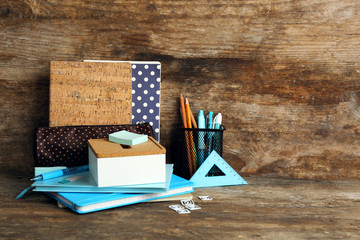 School supplies on old wooden table, close up
