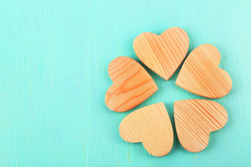 Wooden hearts on color wooden background