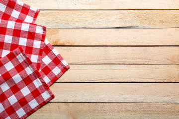 Fototapeta na wymiar Checkered napkin on wooden background