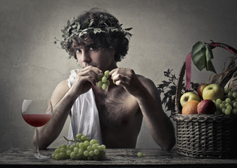 Bacchus holding a bunch of grapes