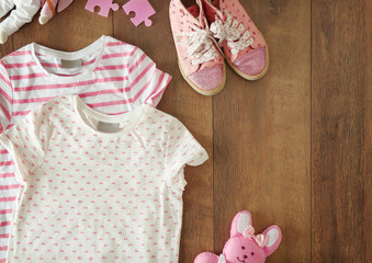 Flat lay children clothing and accessories on wooden background