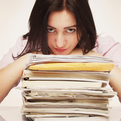 tired and exhausted woman working with documents (psychological