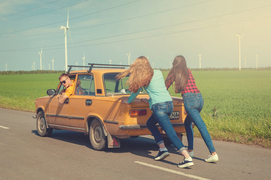 Young hipster friends on road trip on a car