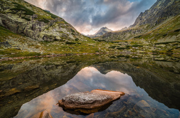 Mountain Lake Above Skok Waterfall with Rocks in Foreground and Strbsky Peak in Background at Sunset. Mlynicka Valley, High Tatra, Slovakia. © kaycco