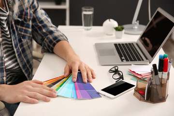 Man working with color samples  at office