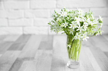 Bouquet of little white flowers on brick wall background