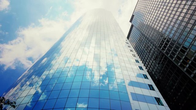 Clouds reflecting over glass windows of New York City skyscraper