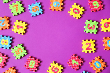 Colorful kids toys on purple background