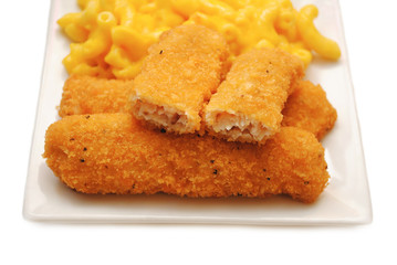 Chicken or Fish Sticks Served on a Plate With Mac & Cheese in the Background