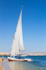 Felucca, traditional wooden sailboat on shore of Nile, Egypt.