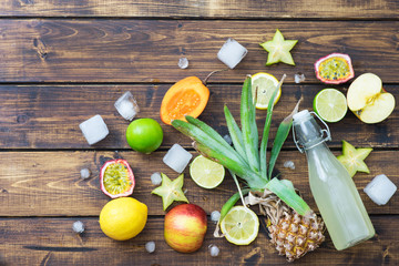 Tropical fruits with ice and bottle of soda