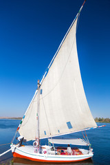 Felucca, traditional wooden sailboat on shore of Nile, Egypt.