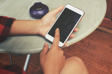 Woman using bluetooth speaker with smart phone