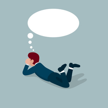 businessman lying down while thinking, dreaming or imagination in bubble space