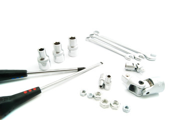screwdrivers, nuts and heads on white