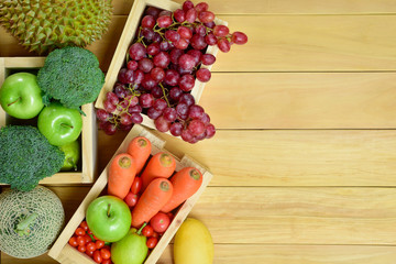 Top view tropical fruits and vegetables at supermarket with copy space