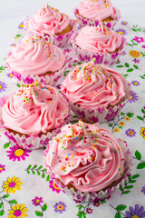 Pink cupcakes  on floral pattern napkin