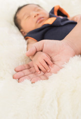 Hand the sleeping baby in the hand of mother close-up (Soft focu