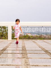 Happy kid, asian baby child walking around action. qipao dress