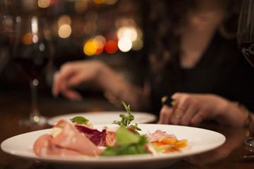 Young woman is eating the appetizer at the bar