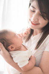 Obraz na płótnie Canvas Happy mother holding adorable child baby boy