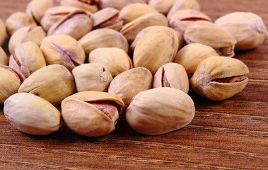 Pistachio nuts on wooden table, healthy eating