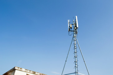 High mast metal structure telecommunication on tower with blue sky.
