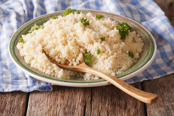 Natural Food: Bulgur with parsley close-up on the table. Horizontal
